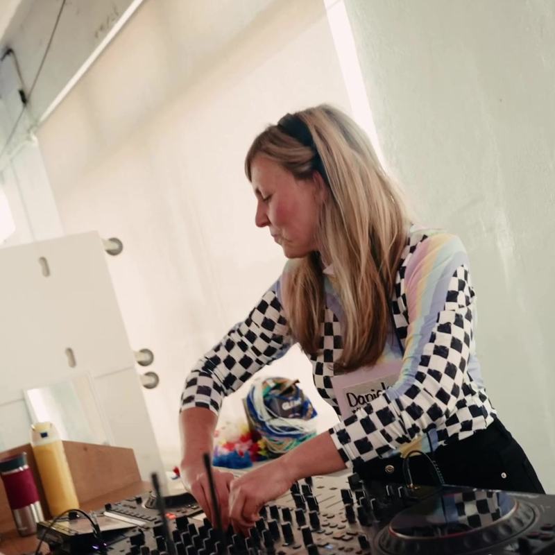 Daniela DJing at the decks at Tiny Rave