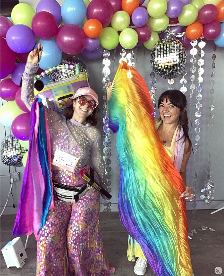 Mandy and Ashley from our crew waving rainbow flags