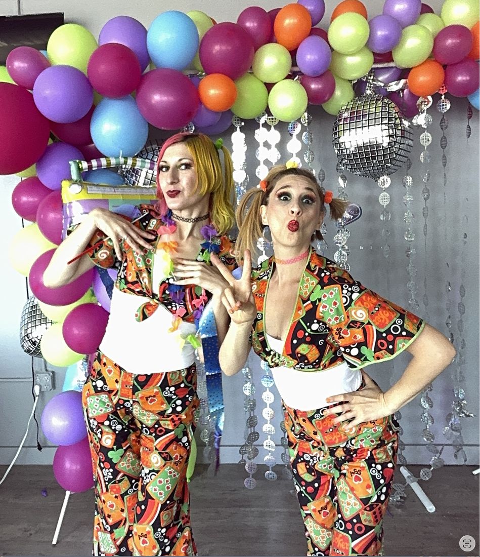 Our magician and face painter posing in matching outfits