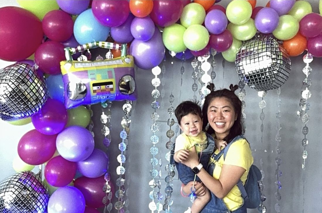 A mom and her baby smiling at the photo booth
